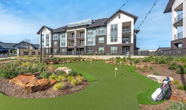 a golf course in front of a large building