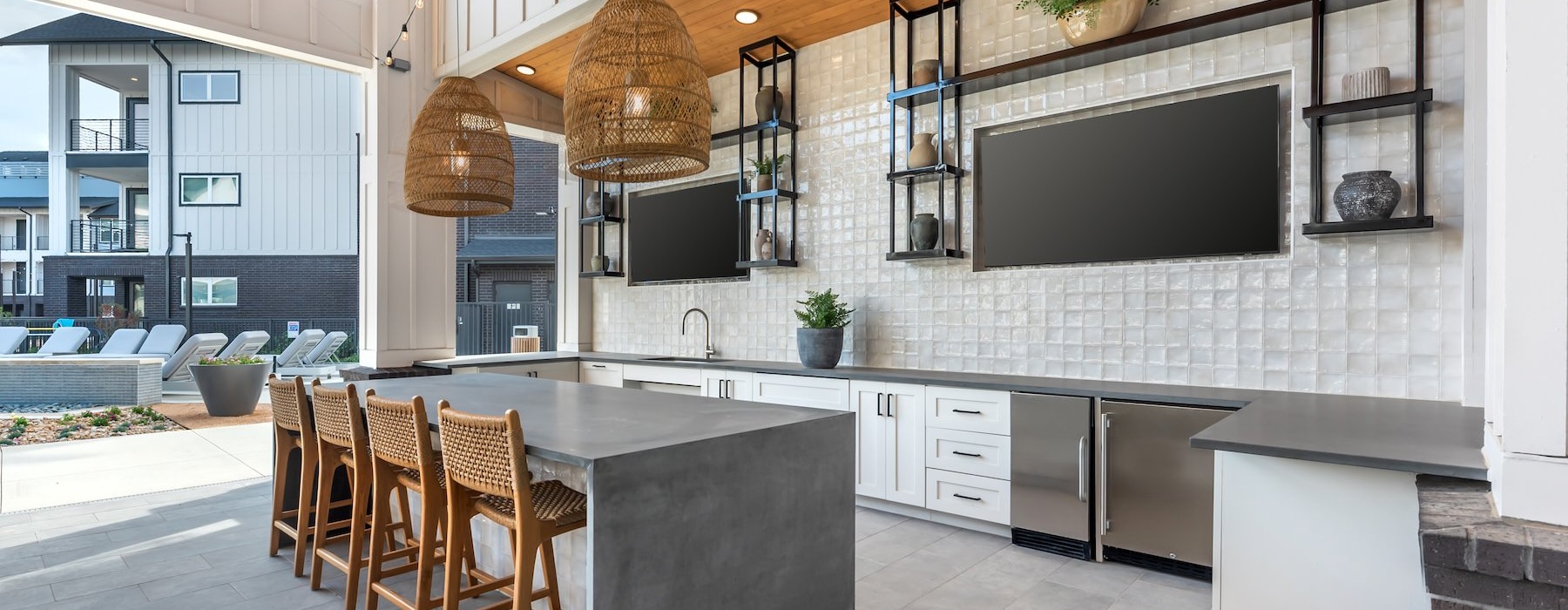 a kitchen with a bar and chairs