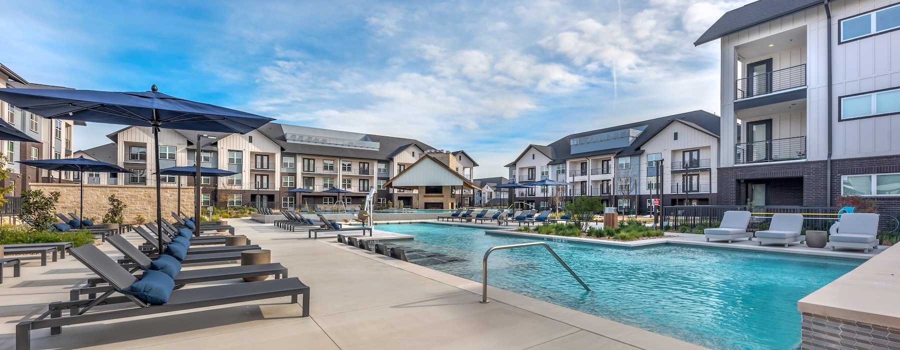 a pool with lounge chairs