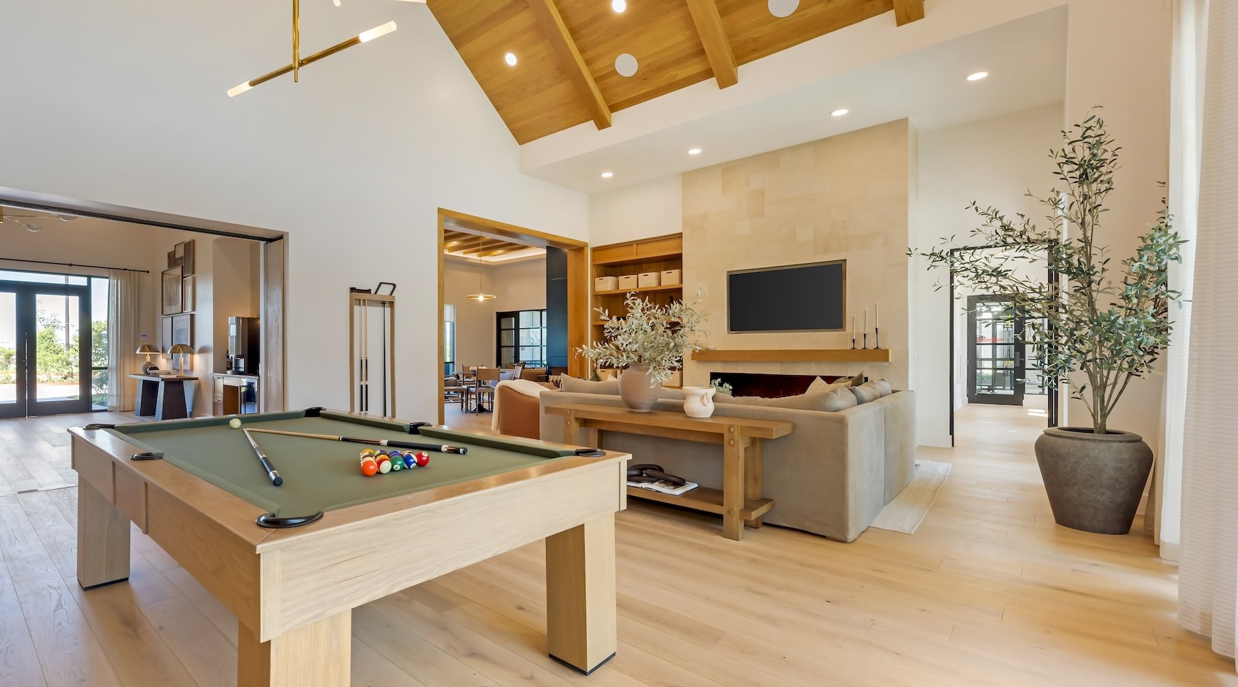 a clubroom with a pool table, couch and a tv