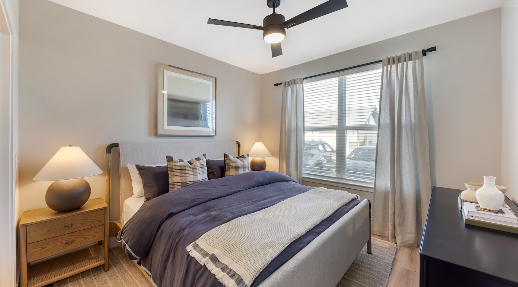 a bedroom with a bed and two nightstands