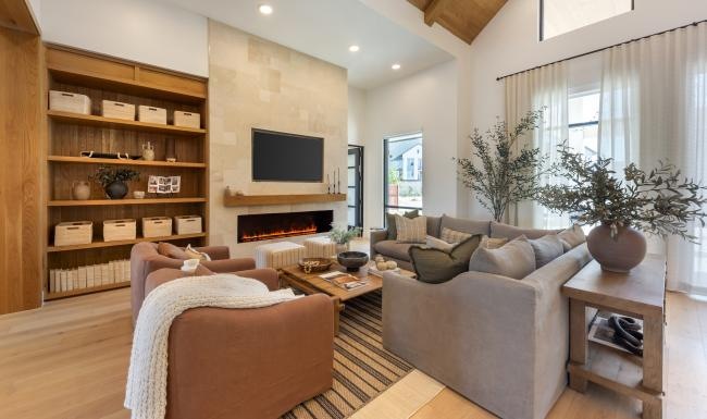 a clubroom with a couch, tv and a fireplace